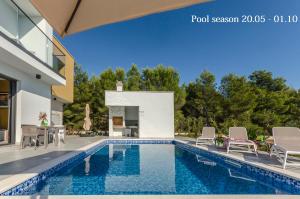 a swimming pool in the backyard of a house at Apartments Villa Adriana I in Srima