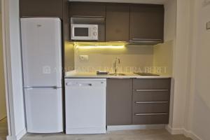 a kitchen with a white refrigerator and a microwave at Apartarent 1500 in Baqueira-Beret