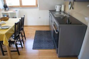 a kitchen with a table and a sink and a counter top at Fewo Karoli in Waldkirchen +6 photos