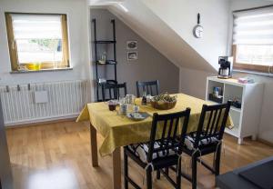 a dining room with a yellow table and chairs at Fewo Karoli in Waldkirchen