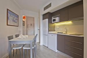 a kitchen with a white table and chairs in a room at Apartarent 1500 in Baqueira-Beret +95 photos