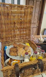 a basket with a tray of pastries on a table at Willowcroft in Alkborough