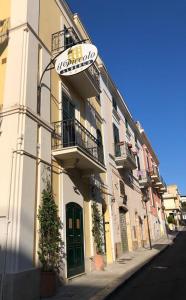 a building with a sign on the side of it at Il Piccolo Albergo Matera in Matera