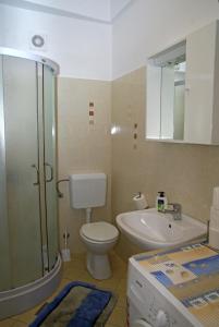 a bathroom with a toilet and a sink and a shower at Apartment Meri- near the Zadar main bus station in Zadar