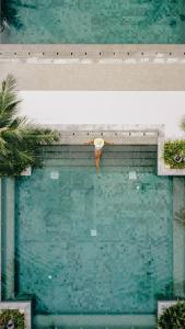 an overhead view of a pool of water with a person at Layana Resort & Spa - SHA Extra Plus in Ko Lanta