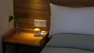 a bed with a wooden headboard and a nightstand next to a bed with at Rock&Wood Cozy House in Hangzhou