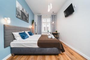 Postel nebo postele na pokoji v ubytování Grace Apartments