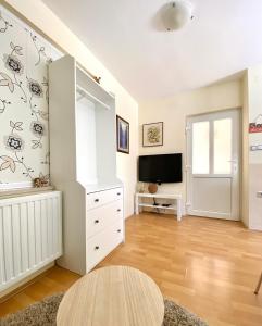a living room with a tv and a table at Apartman Lucija in Gradići