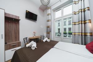 Postel nebo postele na pokoji v ubytování Grace Apartments