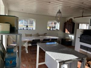 a kitchen with a table and a dining room at Askebo Brygghus in Gislaved