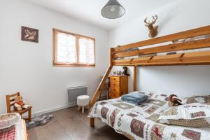 a bedroom with a bed with a wooden bed frame at Macazoline in Xonrupt-Longemer