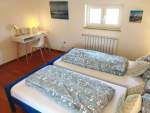 two beds in a room with a table and a desk at Apartment SENA in Vodnjan