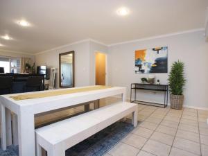 a living room with a table and a couch at Go2Boa Luxury Apartment in Mossel Bay