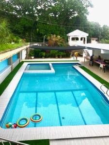 a large swimming pool on a building with at Deluxe Villa Leah Natural Hotspring Resort in Calamba