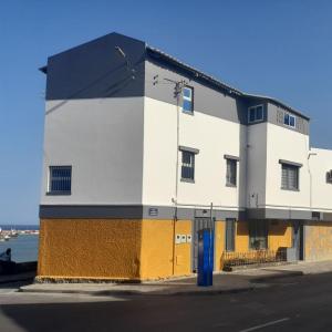 a white and orange building on the side of a street at A Casa da Mizi in Praia