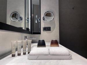 a bathroom with a sink with three toothbrushes at Empark Grand Hotel Beijing in Beijing