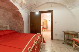 A bed or beds in a room at Trulli da Rosy