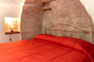 A bed or beds in a room at Trulli da Rosy