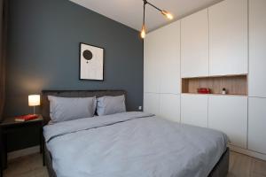 Un pat sau paturi într-o cameră la Olimpia Residence District Satu Mare