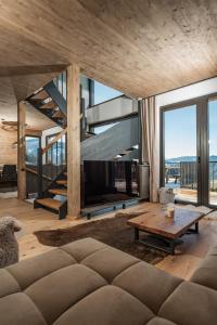 a living room with a couch and a fireplace at Chalet W - auf der Planai -zu jeder Jahreszeit in Schladming