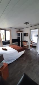 a large bedroom with a large bed and a desk at Logis Auberge des Aulnettes in Houlgate