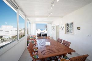 a dining room with a table and chairs on a balcony at WePuglia - Dimora Capitolo in Monopoli