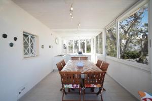 a dining room with a table and chairs and windows at WePuglia - Dimora Capitolo in Monopoli +14 photos