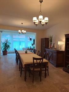a dining room with a table and chairs at Pensiunea Irina in Tilişca