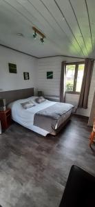 a bedroom with a large bed in a room at Logis Auberge des Aulnettes in Houlgate