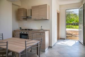 cocina con mesa de madera, mesa y sillas en La Casa del Gelsomino tra Noto e Mare en Noto Marina