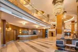 a lobby of a hotel with a bar and chairs at Divan Ankara in Ankara