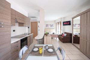 a kitchen with a table and chairs in a room at [Two Steps From Lake] - Lake Maggiore Relax in Dormelletto