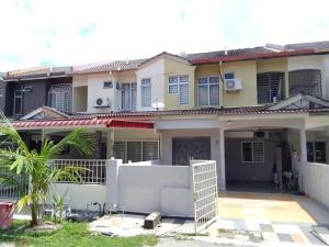 a house with a fence in front of it at Sunny day vacation home fully aircon in Kampong Bagan Lalang
