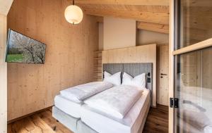 a bedroom with a large bed with white pillows at Kessler's Mountain Lodge in Natz-Schabs