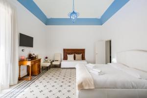 Posteľ alebo postele v izbe v ubytovaní Palazzo Montalbano