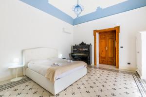 Posteľ alebo postele v izbe v ubytovaní Palazzo Montalbano