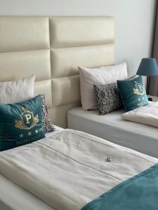 a bedroom with two beds with pillows and a headboard at Hotel Post Sindelfingen in Sindelfingen