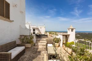 a balcony of a house with a view of the ocean at Casa degli Amici by BarbarHouse in Ostuni