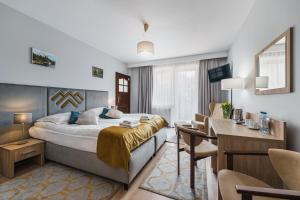 Televízia a/alebo spoločenská miestnosť v ubytovaní Hotel Smile Pieniny