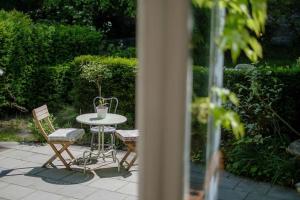 a table and two chairs and a table and a table at La Calamande En Ville in Brussels