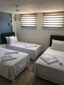 A bed or beds in a room at Ersin Konak