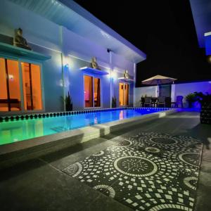 a house with a swimming pool at night at Sparrow's Nest in Panglao