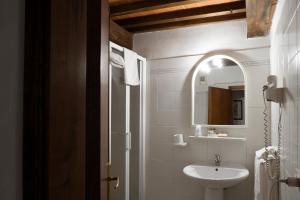 a bathroom with a sink and a mirror at Albergo Del Chianti in Greve in Chianti