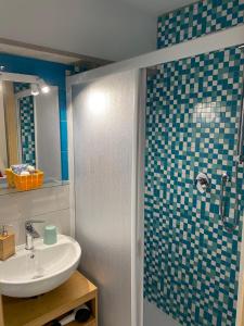 a bathroom with a sink and a shower at LAGUNA BLU Camera TRAMONTO con terrazza panoramica in comune in Chioggia +49 photos