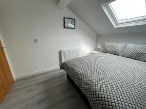 a bedroom with a bed and a window at Hosted By Ryan - Anfield Apartments in Liverpool