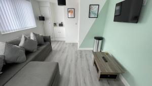 a living room with a couch and a coffee table at Hosted By Ryan - Anfield Apartments in Liverpool