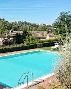 a swimming pool in a yard with a chair at Borgo Grondaie in Siena