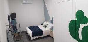 a bedroom with a bed and a cactus at fico d'india in Spadafora