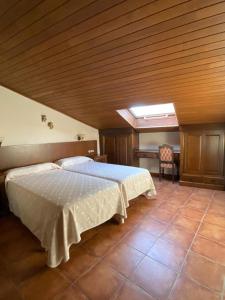 a bedroom with a bed and a skylight at Casa rural osvilares in Santiago de Compostela