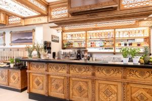 a bar in a restaurant with wooden cabinets at Aparthotel Białczański in Białka Tatrzańska